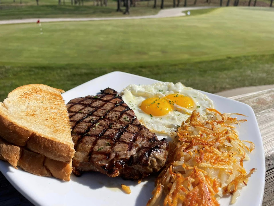 A plate of food with a lawn in the background

Description automatically generated